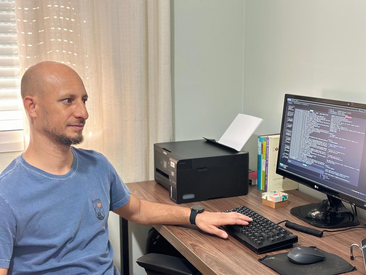 A person sitting at a desk in front of a computer